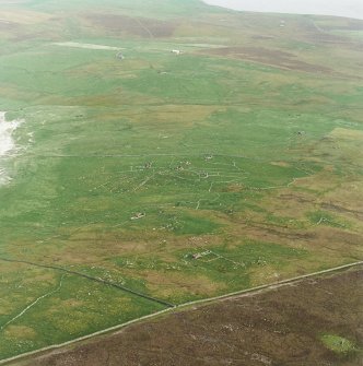 Oblique aerial view centred on the remains of the township and head-dyke, taken from the NW.