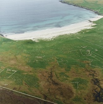 Oblique aerial view centred on the remains of the township and head-dyke, with the remains of the Viking settlement adjacent, taken from the WNW.