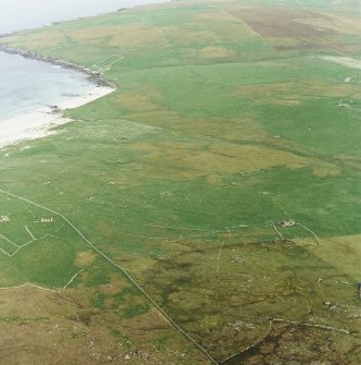 Oblique aerial view centred on the remains of the township and head-dyke, with the remains of the Viking settlement adjacent, taken from the WNW.