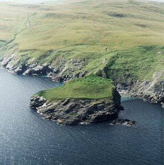 Oblique aerial view centred on the remains of the monastic settlement, taken from the E.