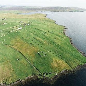Oblique aerial view centred on the remains of the township, chapel,  burial ground and head-dyke, taken from the NNW.
