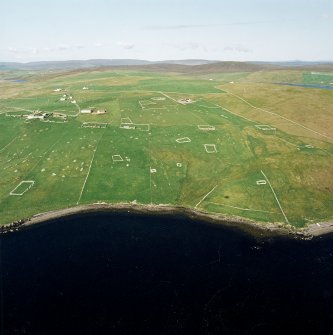 Oblique aerial view centred on the remains of the township, chapel,  burial ground and head-dyke, taken from the WSW.
