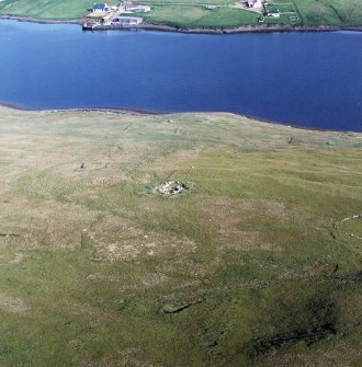 Oblique aerial view centred on the remains of the settlement and field-system, taken from the NNW.