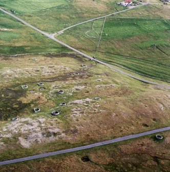 Oblique aerial view centred on the remains of the planticrubs and quarries, taken from the NNE.