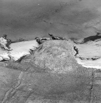 Oblique aerial view centred on the remains of the broch, taken from the W.