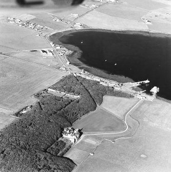 Oblique aerial view of Orkney, Shapinsay, Balfour Castle, Balfour village and harbour taken from the W.  Also visible is the former Balfour village gasometer