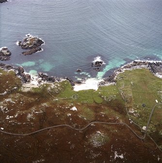 Oblique aerial view centred on the remains of the township and lazy beds with the remains of the radar station and possible nunnery adjacent, taken from the E.