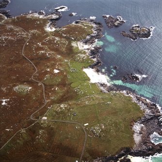 Oblique aerial view centred on the remains of the township and lazy beds with the remains of the radar station and possible nunnery adjacent, taken from the N.