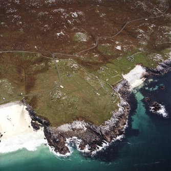 Oblique aerial view centred on the remains of the township and lazy beds with the remains of the radar station and possible nunnery adjacent, taken from the NW.
