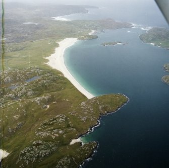 General oblique aerial view looking across the beach at Traigh na Berie towards the townships, taken from the ESE.
