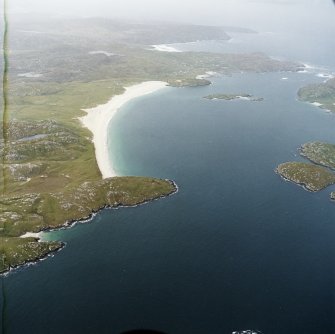 General oblique aerial view looking across the beach at Traigh na Berie towards the townships, taken from the E.