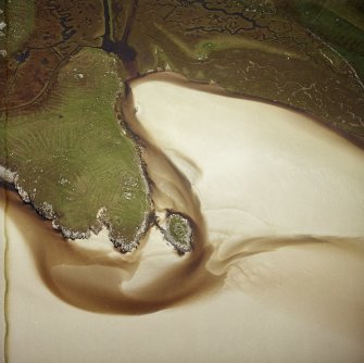 Oblique aerial view centred on the remains of the galleried dun with the remains of lazy beds adjacent, taken from the SW.