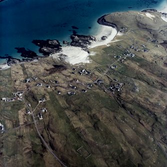 Oblique aerial view centred on the townships and the remains of the buildings with the burial ground adjacent, taken from the W.