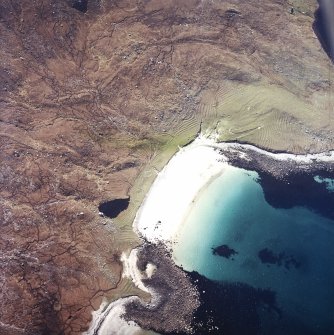 Oblique aerial view centred on the remains of the shieling huts and lazy-beds, taken from the NE.

