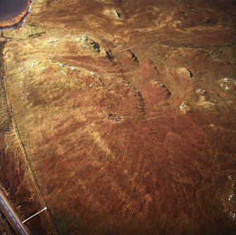 Oblique aerial view centred on the remains of the stone circle, taken from the ENE.