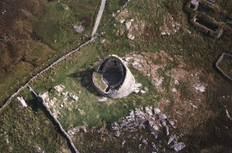 Oblique aerial view centred on the remains of the broch, taken from the W.