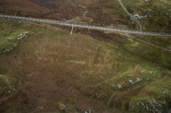 Oblique aerial view centred on the remains of the stone circle, taken from the WNW.