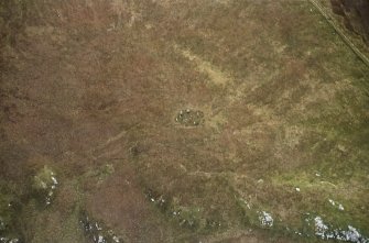 Oblique aerial view centred on the remains of the stone circle, taken from the W.