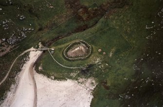 Oblique aerial view centred on the reconstructed house, taken from the NW.