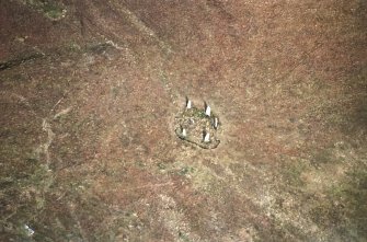 Oblique aerial view centred on the remains of the stone circle, taken from the S.