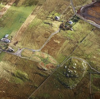 Oblique aerial view centred on the remains of the stone circle, chambered cairn and stone alignments with the township and lazy beds adjacent, taken from the WSW.