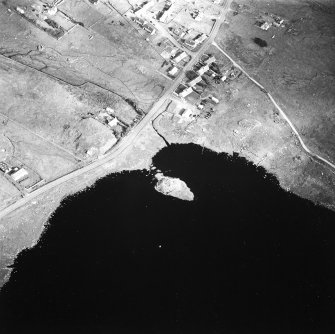 Oblique aerial view centred on remains of the broch with the possible crannog adjacent, taken from the SW.