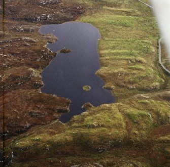 Oblique aerial view centred on the remains of the dun, taken from the N.