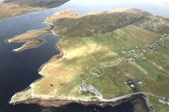 General oblique aerial view looking across the remains of the stone circle, stone alignments and township, taken from the SE.