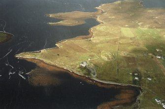 General oblique aerial view centred on the remains of the stone circle, chambered cairn and stone alignments with the farmhouse, visitor centre and township adjacent, taken from the ESE.