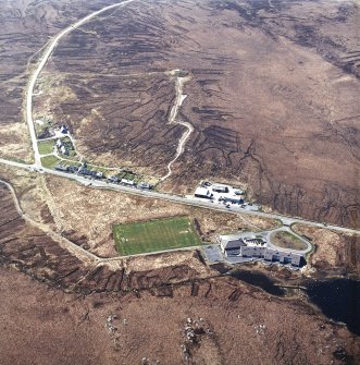 Oblique aerial view centred on the school and houses, taken from the ESE.
