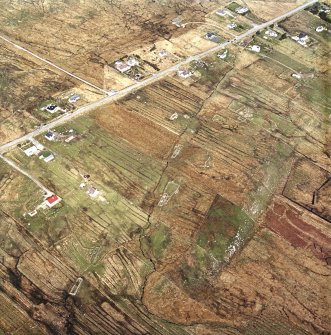 Oblique aerial view centred on the township and the remains of the buildings, taken from the SW.