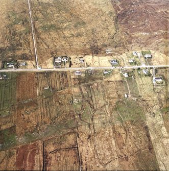 Oblique aerial view centred on the township, the remains of the buildings, the school and church, taken from the SSW.