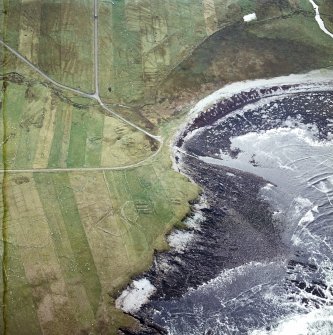 Oblique aerial view centred on the remains of the chapel with the remains of the township adjacent, taken from the NW.