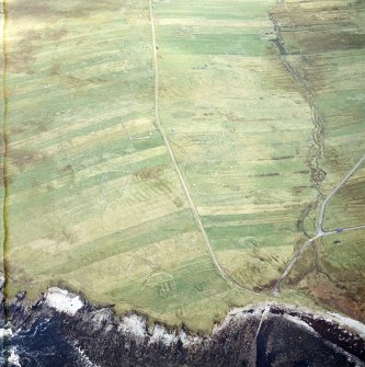 Oblique aerial view centred on the remains of the township with the remains of the chapel adjacent, taken from the WSW.