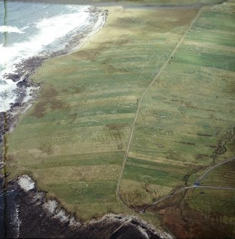 Oblique aerial view centred on the remains of the township with the remains of the chapel adjacent, taken from the SW.