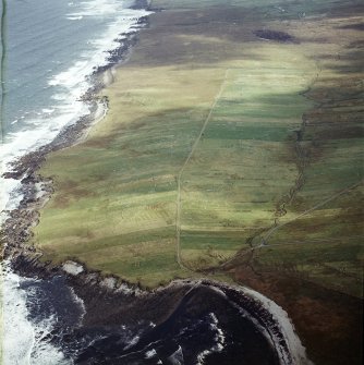 Oblique aerial view centred on the remains of the township with the remains of the chapel adjacent, taken from the SW.