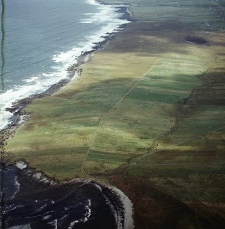 Oblique aerial view centred on the remains of the township with the remains of the chapel adjacent, taken from the SW.