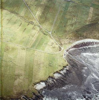 Oblique aerial view centred on the remains of the chapel with the remains of the township adjacent, taken from the NW.