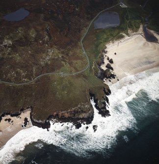 Oblique aerial view centred on the remains of the lazy beds and possible promontory fort with the dun and possible shieling-hut, adjacent, taken from the E.