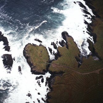 Oblique aerial view centred on the remains of the settlement with the remains of lazy beds adjacent, taken from the W.