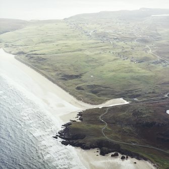 General oblique aerial view looking across the remains of the dun towards Tolstadh Traigh Mor beach, taken from the NNE.