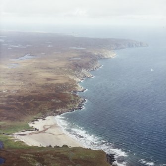 General oblique aerial view looking across the remains of the dun along the east coast of Lewis, taken from the S.