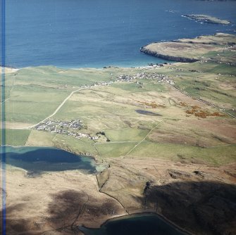 General oblique aerial view looking across the village towards the crofting township and radar station, taken from the WSW.