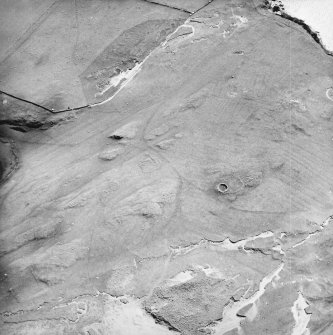 Oblique aerial view centred on the remains of the hut-circles, farmstead and rig with the farmstead adjacent, taken from the NNW.