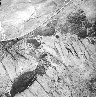 Achnahuie, East Langwell, Cnoc Achadh na h-Uaighe, oblique aerial view, taken from the ENE, showing small cairns in the centre of the photograph, and the remains of a building and small cairns in the upper left-hand corner. An area with a hut-circle, small cairns, lynchets and a possible hut is visible in the upper right-hand corner.