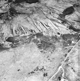 Cnoc Achadh na h-Uaighe, Achnahuie, oblique aerial view, taken from the WSW, showing small cairns and an area with a hut-circle, small cairns, lynchets and a possible hut in the centre of the photograph.