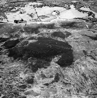 Cnoc Cairaidh, Achnagarron, oblique aerial view, taken from the NE, centred on an area with hut-circles, a field-system and possible cord rig. Standing stones, small cairns and a building are visible in the centre top half of the photograph.