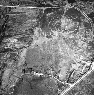 Dremergid, oblique aerial view, taken from the SE, centred on an area defined as an archaeological landscape, and burnt mound. The remains of a building is visible in the bottom left-hand corner of the photograph.