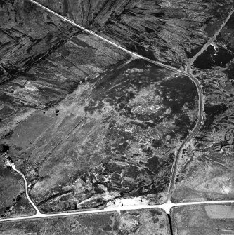 Dremergid, oblique aerial view, taken from the SE, centred on an area defined as an archaeological landscape, and burnt mound. A hut-circle, small cairns and a bank is visible in the bottom right-hand side of the photograph.