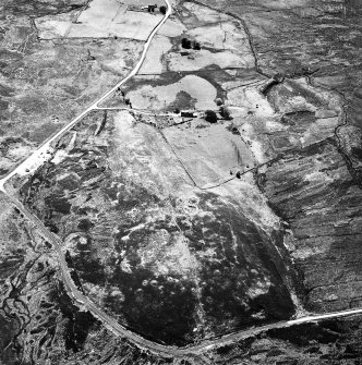 Dremergid, oblique aerial view, taken from the NW, centred on an area defined as an archaeological landscape, and burnt mound. A building and a farmstead is visible in the centre and top half of the photograph.